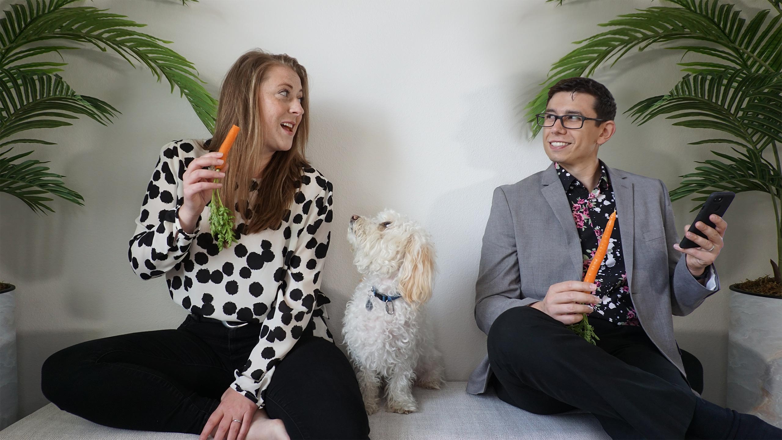 Tenacious Marketing Co-Founders Tanita and Nichoals Antonio eat carrots while sitting with thier dog