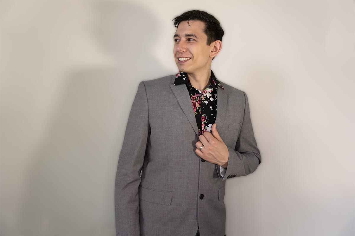 Nicholas Antonio wearing business casual in front of a white backdrop